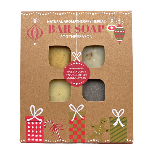 Plantlife Holiday Bar Soap Set featuring four natural aromatherapy herbal soaps in Peppermint, Cassia Clove, Frankincense, and Sandalwood, in festive gift packaging.
