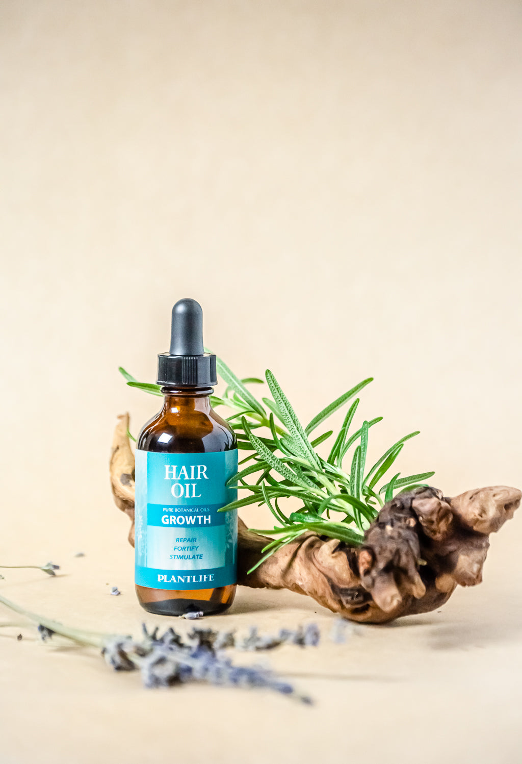 Plantlife Hair Growth Oil with rosemary and lavender on natural wood background, promoting natural hair care and growth.