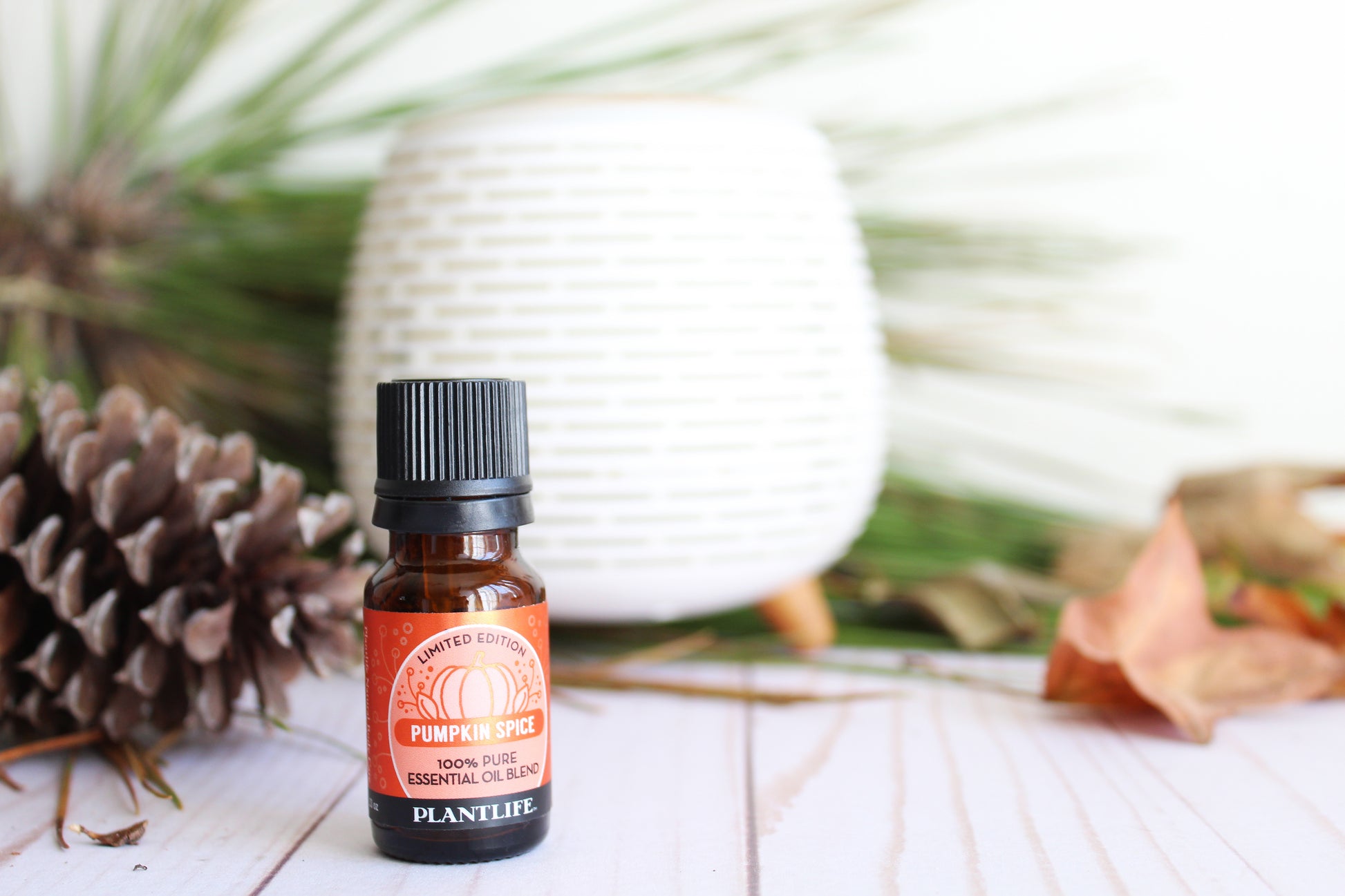 Small bottle of Pumpkin Spice essential oil with a blurred natural background