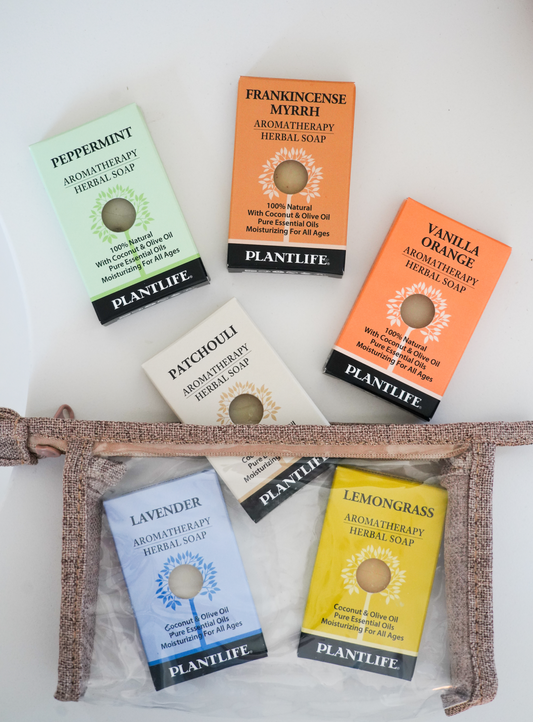 Plantlife Aromatherapy Herbal Soaps in assorted scents including Lavender, Patchouli, Peppermint, and more, displayed with a transparent travel pouch for natural skincare on the go.
