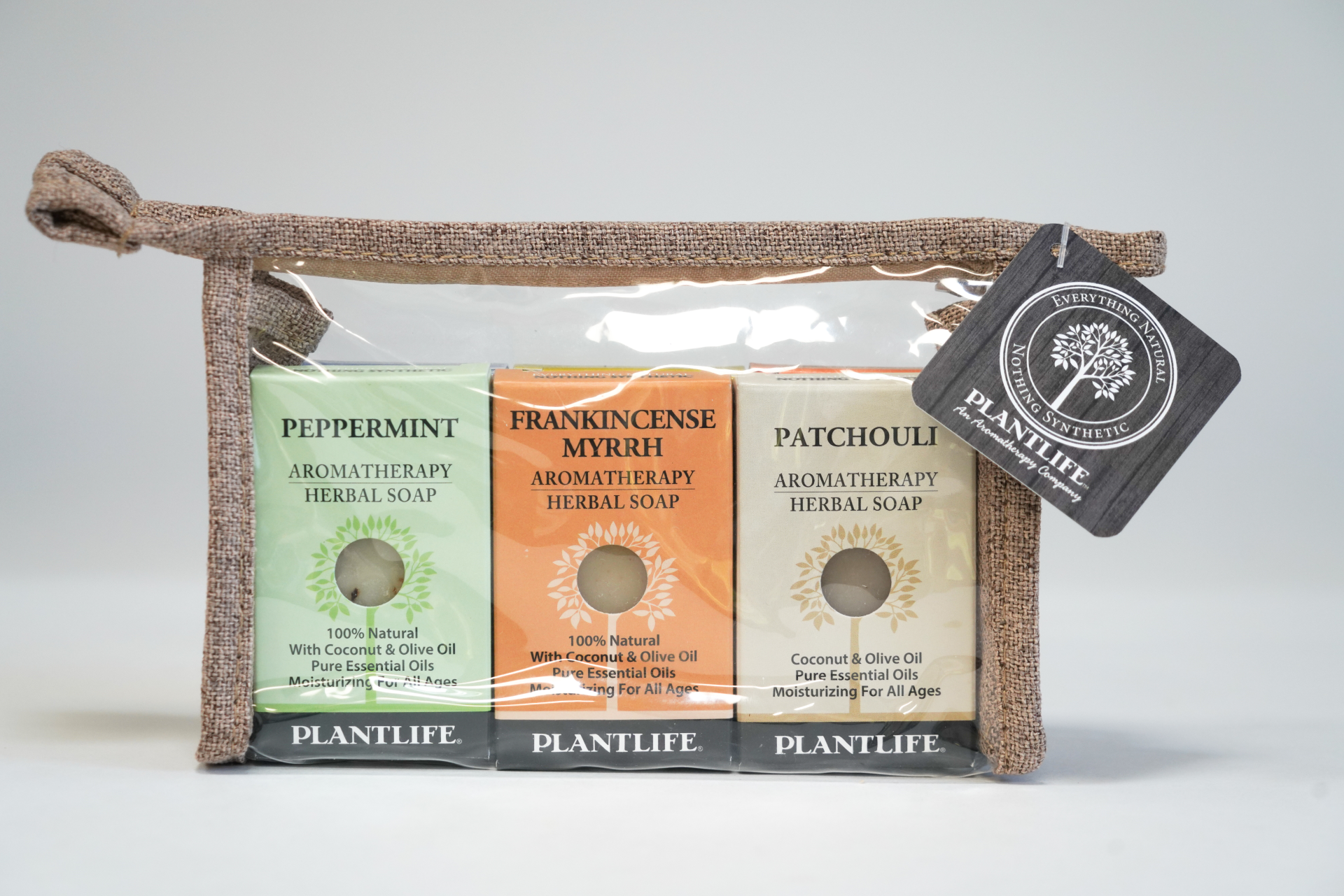 Plantlife Aromatherapy Herbal Soap 3-pack featuring Peppermint, Frankincense Myrrh, and Patchouli soaps in a reusable travel pouch with a Plantlife branded tag.