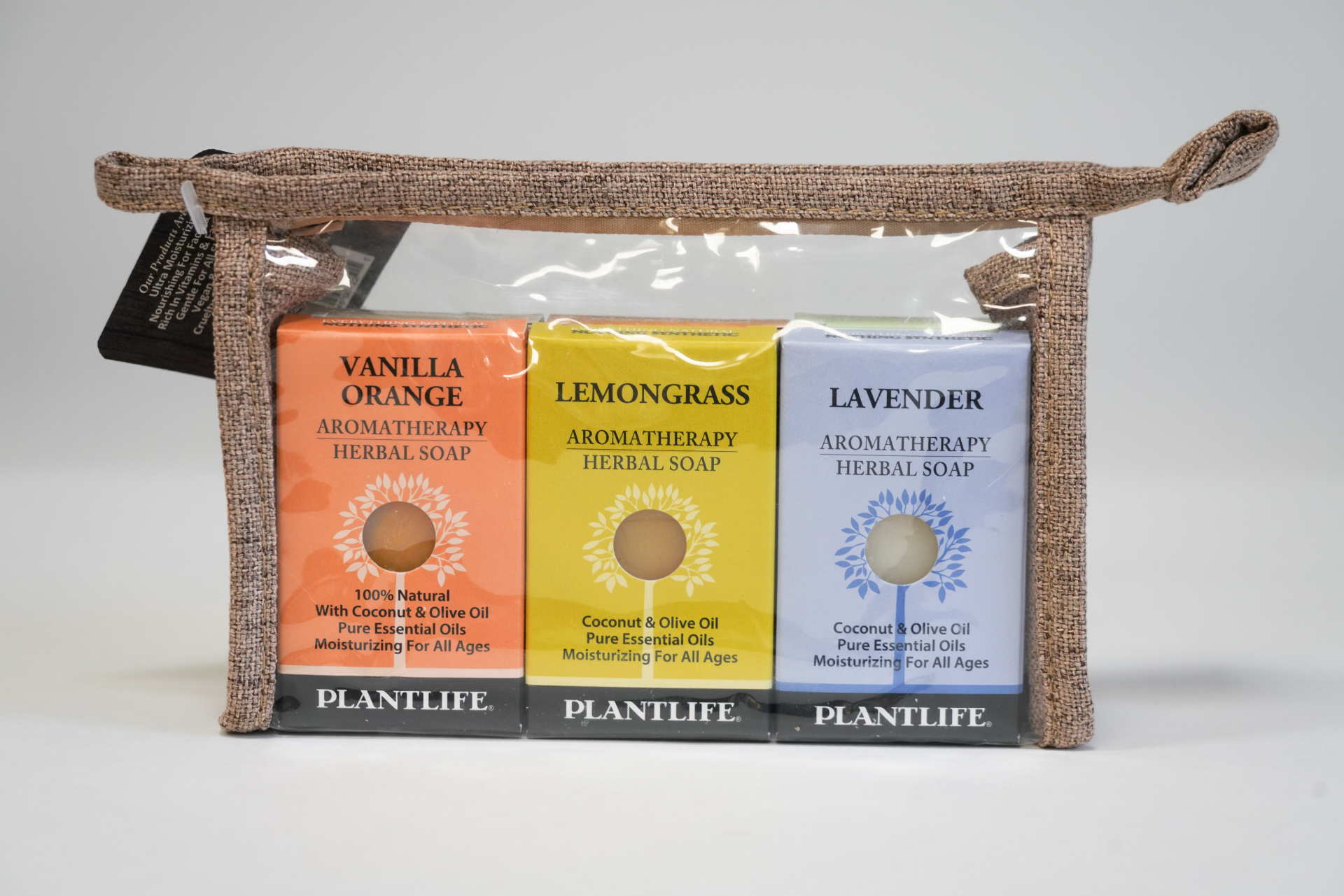 Plantlife Aromatherapy Herbal Soap 3-pack featuring Vanilla Orange, Lemongrass, and Lavender soaps in a clear travel pouch with a textured brown fabric trim.