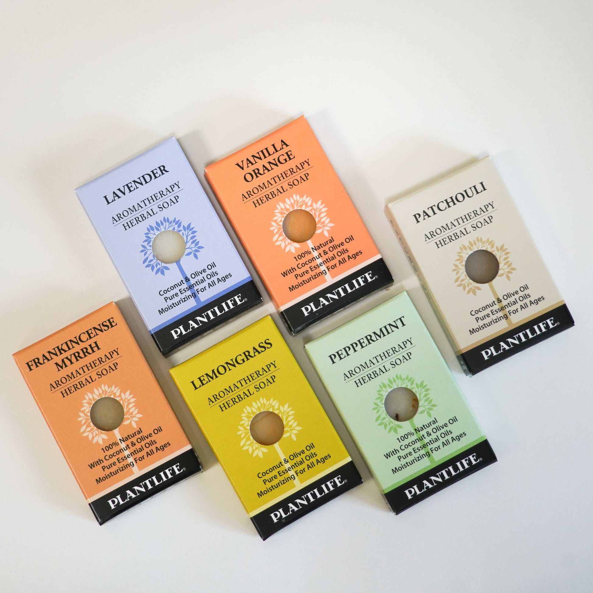 Six Plantlife Aromatherapy Herbal Soap bars arranged on a white surface, including Lavender, Vanilla Orange, Patchouli, Frankincense Myrrh, Lemongrass, and Peppermint varieties.