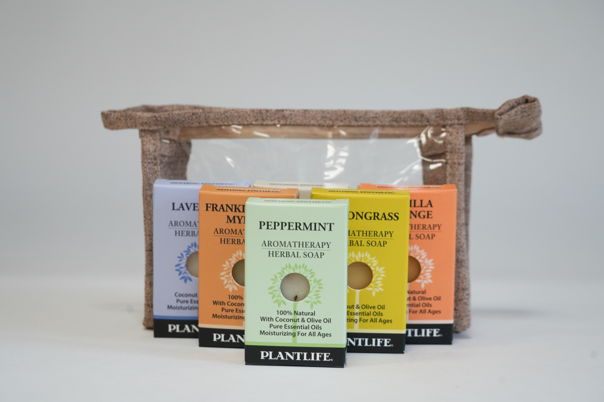 Plantlife Aromatherapy Herbal Soap Gift Set featuring six assorted natural bar soaps, including Peppermint, Lemongrass, Vanilla Orange, Frankincense Myrrh, and Lavender, arranged in front of a reusable eco-friendly pouch.