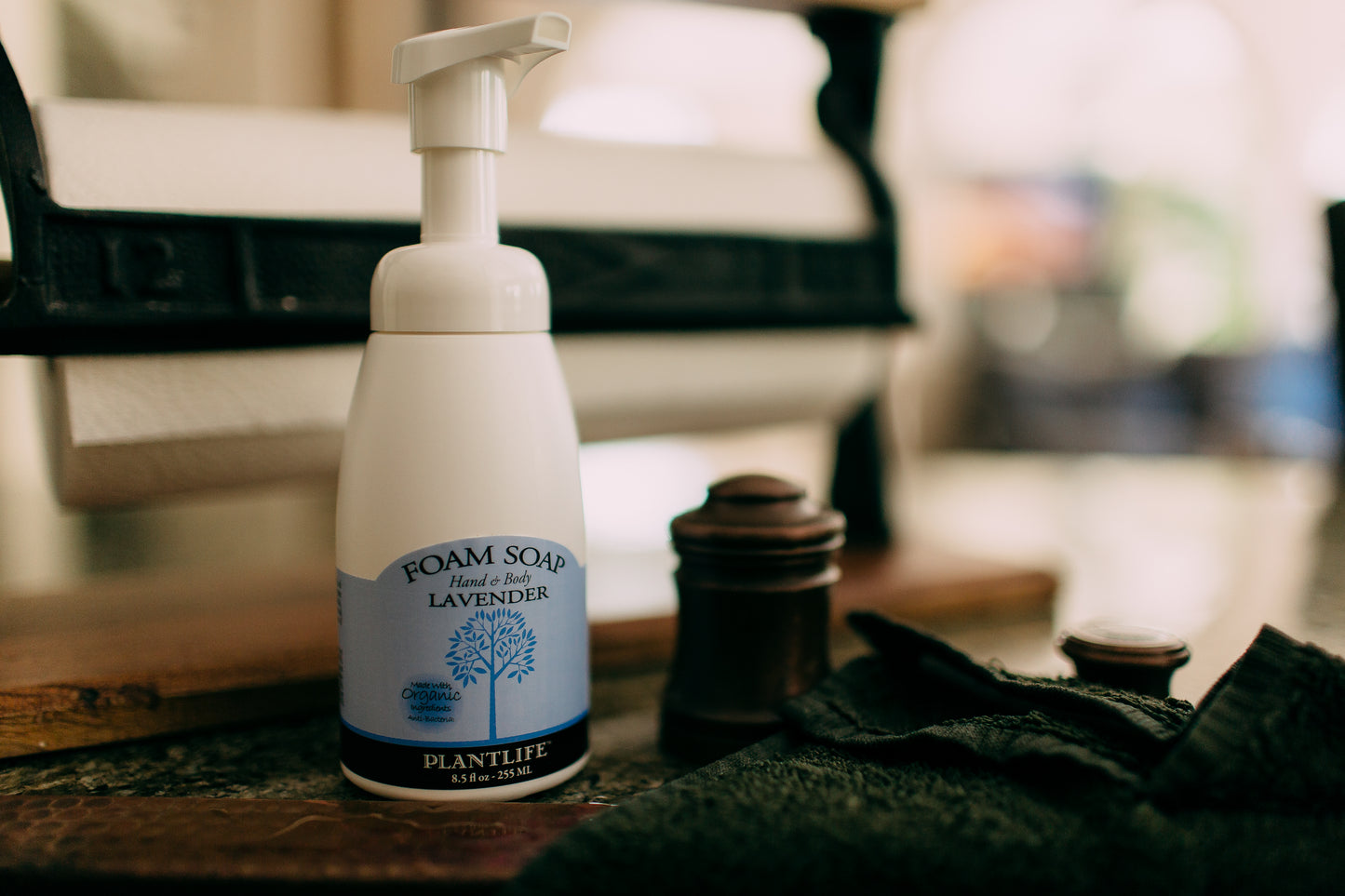 Foam soap bottle with lavender scent on a wooden surface
