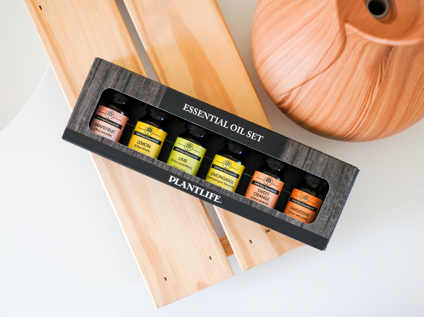 Essential oil set by Plantlife on a wooden surface