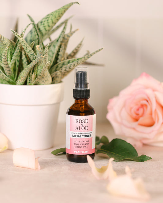 PLANTLIFE Rose & Aloe Facial Toner on a marble surface with a potted plant and rose petals in the background