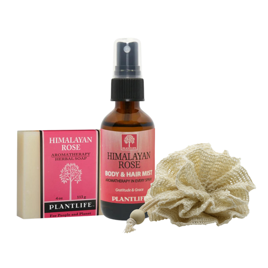 Plantlife Himalayan Rose gift set including aromatherapy herbal soap, body and hair mist spray, and natural exfoliating bath pouf on transparent background