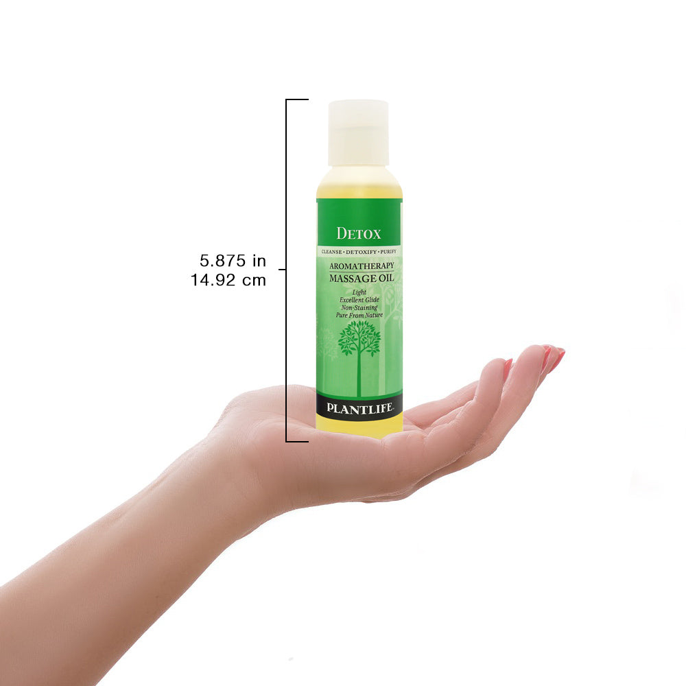 Plantlife Detox massage oil bottle shown next to scale for size reference and product detail.