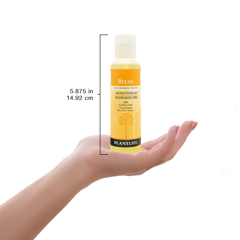 Plantlife Relax massage oil bottle shown with scale for size reference and product detail.