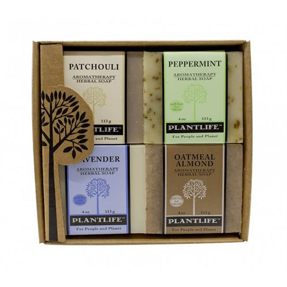 Plantlife Aromatherapy Herbal Soap Gift Set featuring four 4oz bars in Patchouli, Peppermint, Lavender, and Oatmeal Almond scents in a kraft gift box.