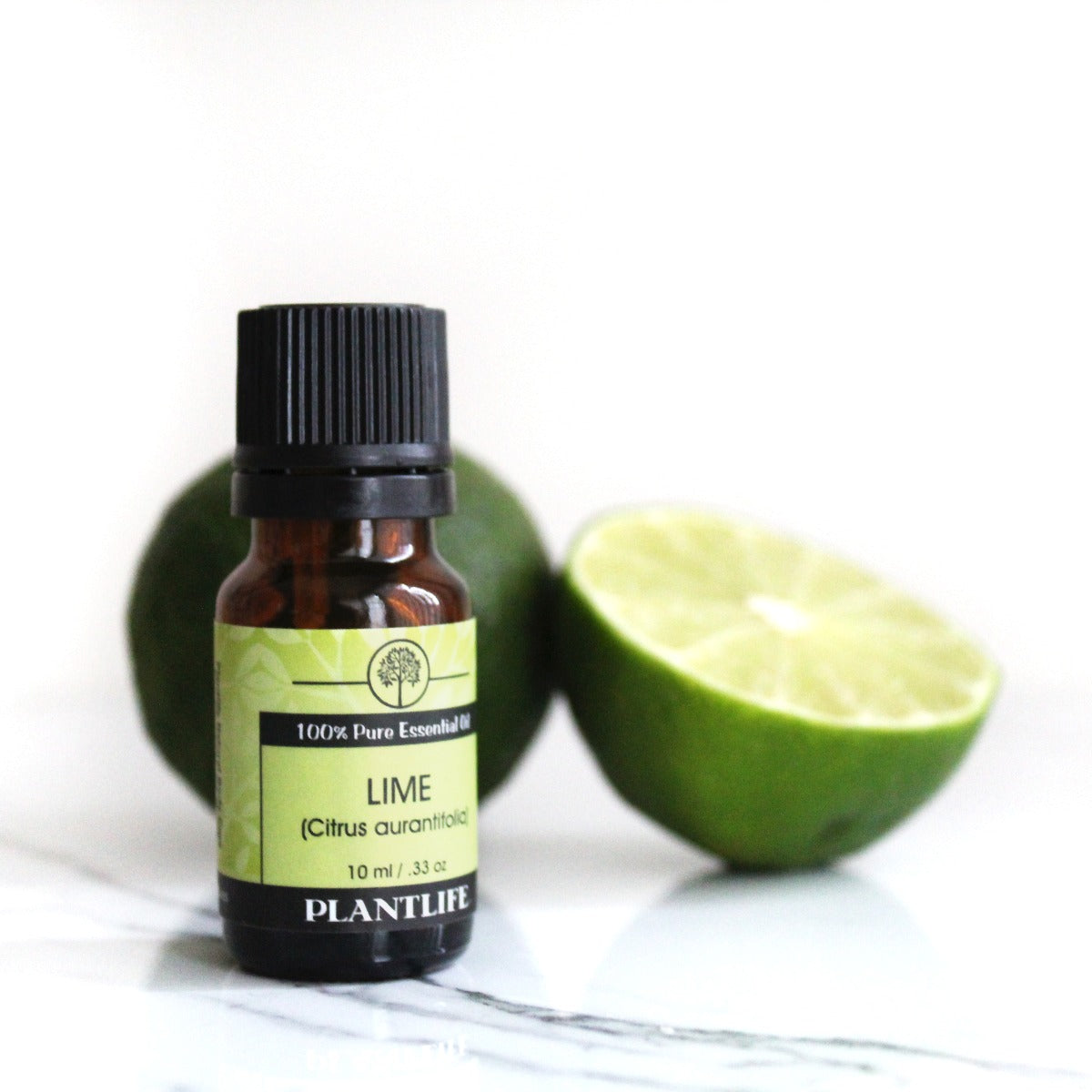 Plantlife Lime Essential Oil bottle with sliced lime and green backdrop