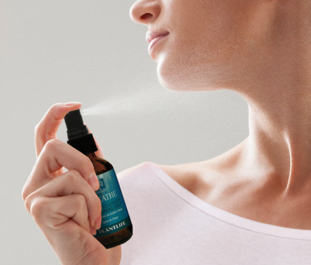 Woman spraying Plantlife Breathe Essential Oil Mist for natural aromatherapy