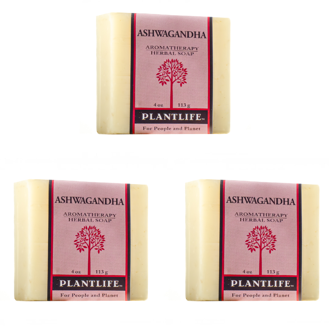 Three bars of Plantlife Ashwagandha Herbal Soap arranged on a plain white background, with one bar at the top and two at the bottom. Each bar has a pale cream-colored soap body and a pink label with a red tree logo and black text.