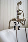 Panda-shaped bath toy hanging from a faucet in a bathroom setting