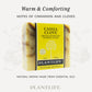 Plantlife Cassia Clove Aromatherapy Herbal Soap in yellow packaging with visible brown swirls in the soap. Text reads “Warm & Comforting – Notes of cinnamon and cloves” and “Natural aroma made from essential oils.”