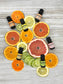 Essential oil bottles with citrus fruits on a wooden surface