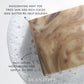 Close-up of a brown and cream swirled Plantlife soap bar resting in bubbly water. Text on the image highlights “Invigorating mint for tired skin and rich cocoa seed butter to help nourish” and “Rich lather, moisturizing and gentle on skin.”