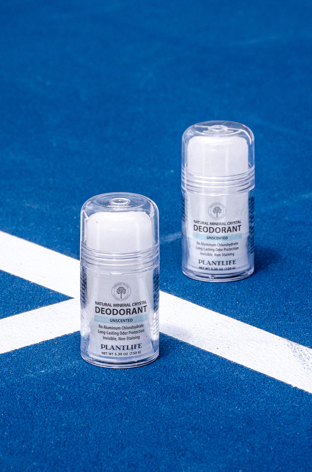 Plantlife unscented mineral crystal deodorant sticks on blue court for natural active odor protection