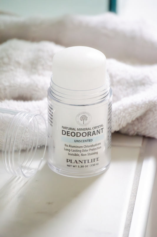Plantlife natural mineral crystal deodorant on a white surface with a towel in the background