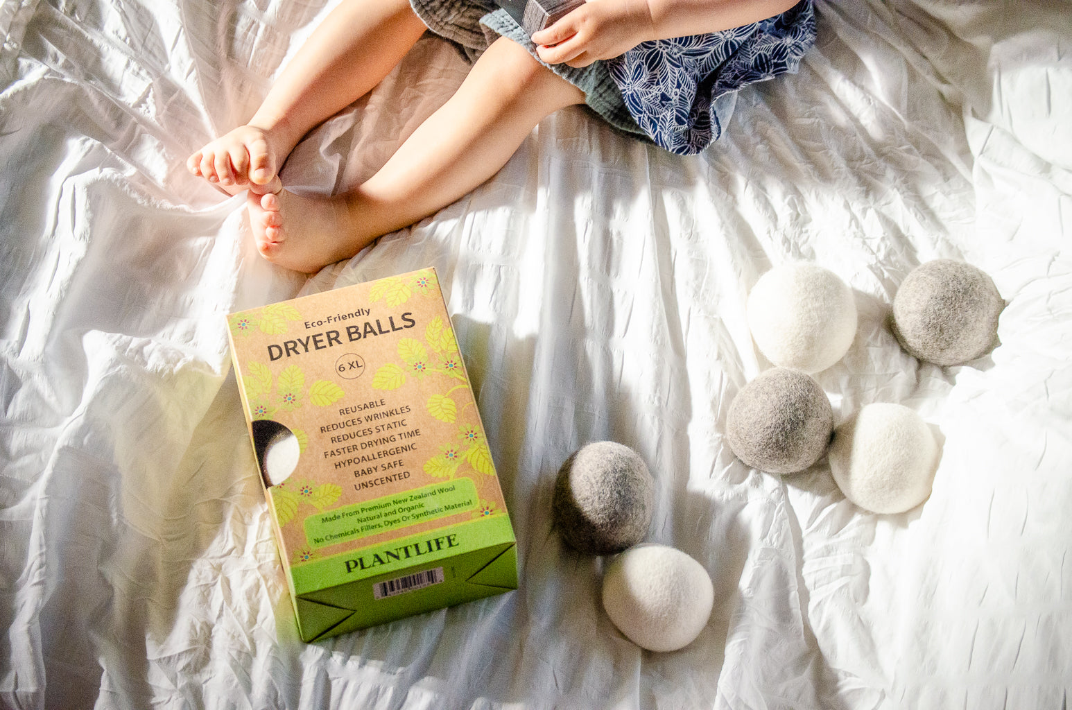 Dryer balls and packaging on a bed