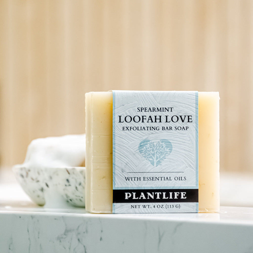 Bar of soap with 'Loofah Love' packaging on a marble surface