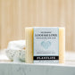 Bar of soap with 'Loofah Love' packaging on a marble surface