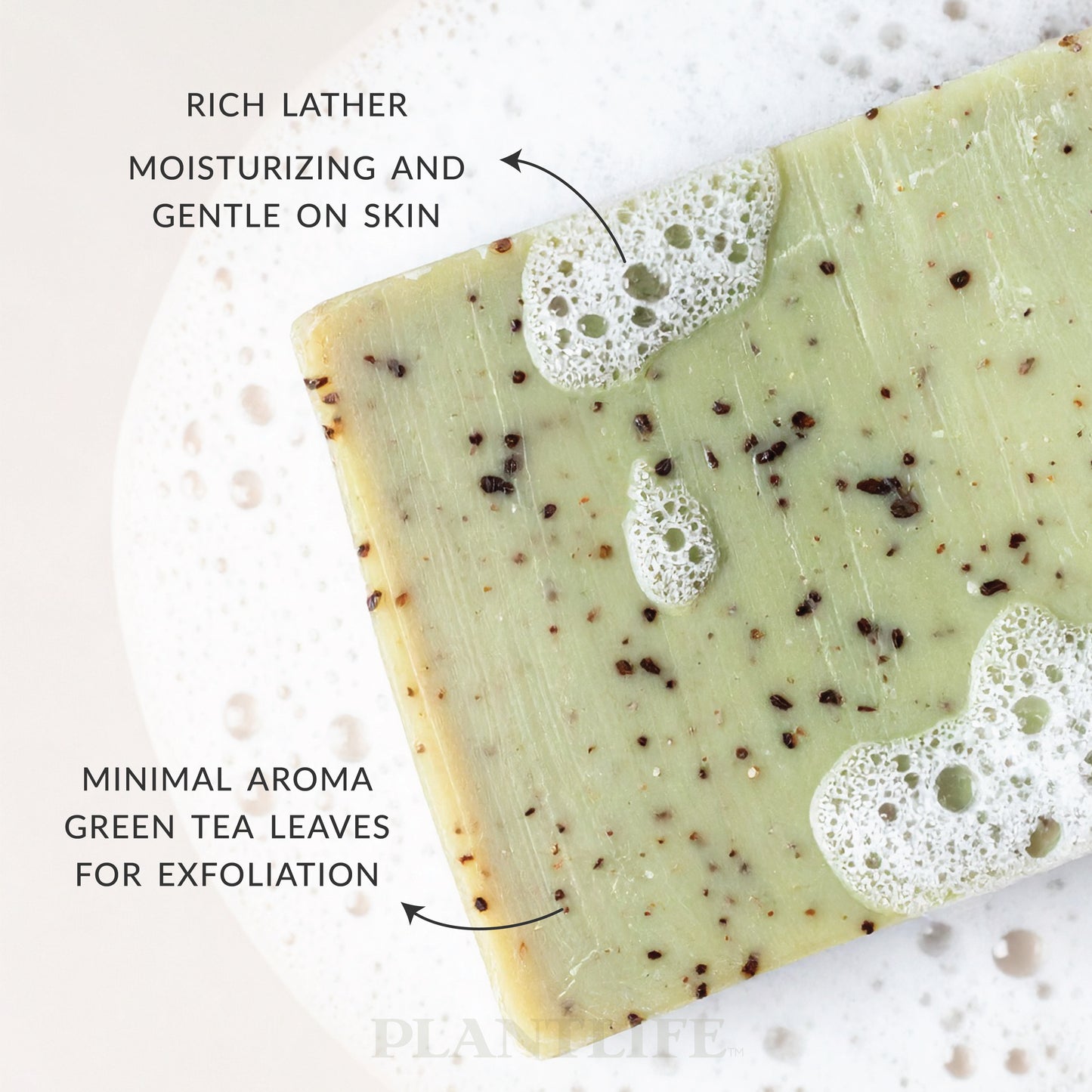 Close-up of Plantlife Green Tea Soap bar with visible green tea leaf specks and soft bubbles. Text reads “Rich lather moisturizing and gentle on skin” and “Minimal aroma green tea leaves for exfoliation.” Plant-based natural soap designed for a mild cleanse with gentle exfoliation and skin-balancing properties.