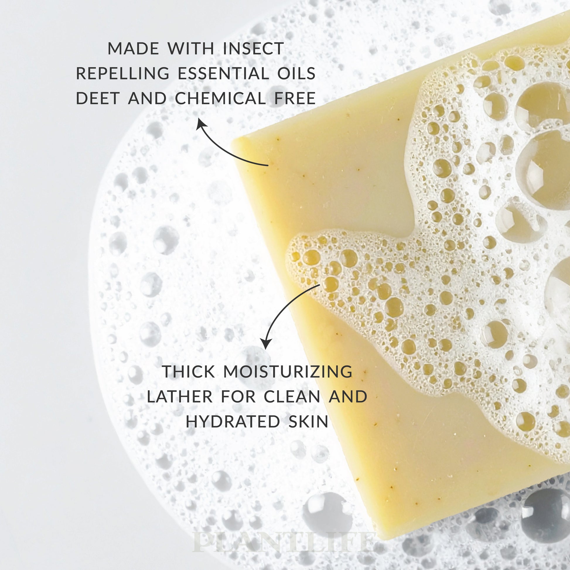 Plantlife bar soap resting on a layer of foamy bubbles, shown with a smooth golden-yellow color and airy lather. Text highlights that it’s made with insect-repelling essential oils, free of DEET and chemicals, and produces thick moisturizing lather for clean, hydrated skin.