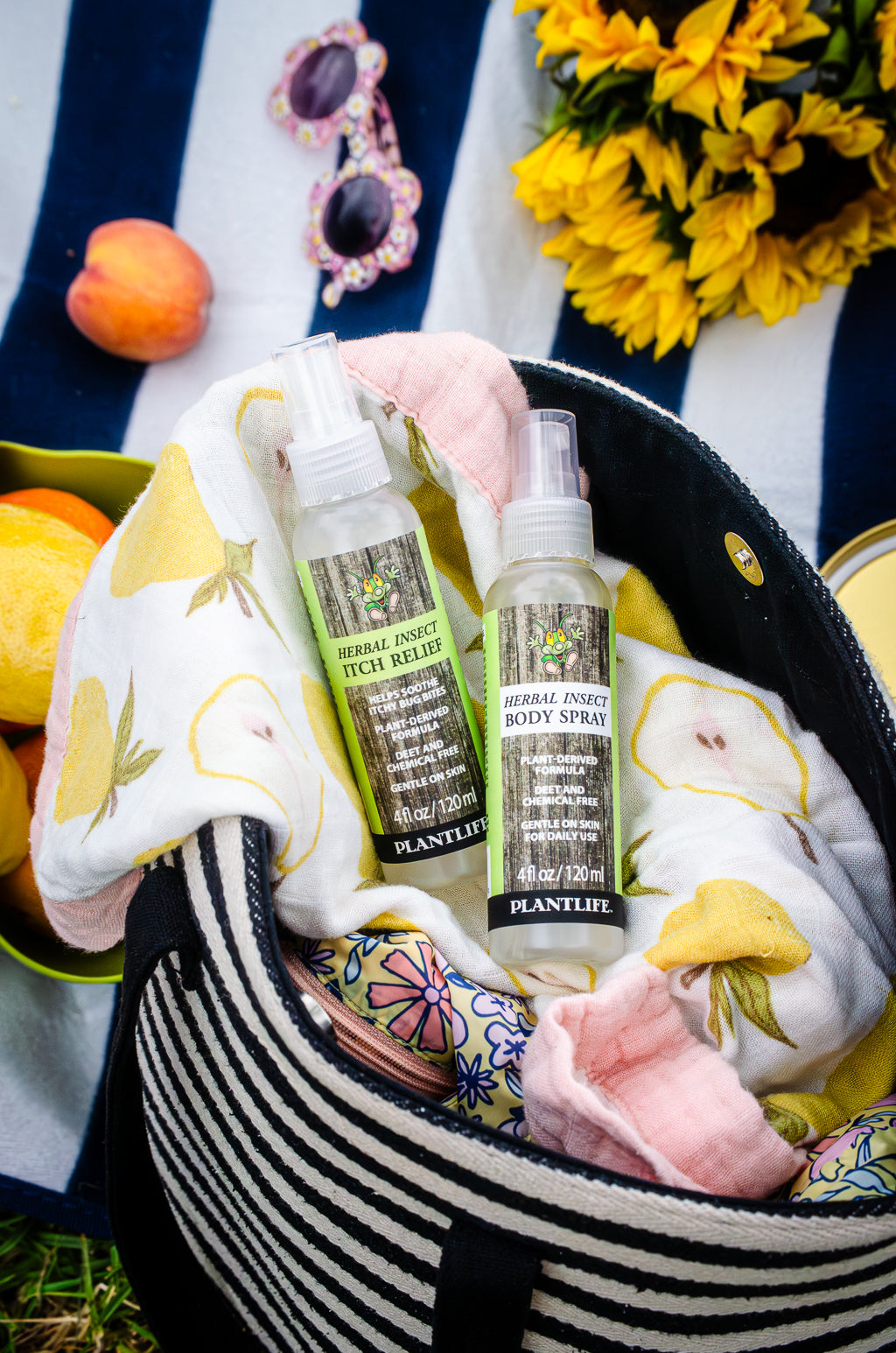 Plantlife Herbal Insect Itch Relief Spray and Herbal Insect Body Spray 4 fl oz bottles in a picnic bag for DEET-free outdoor skin care and after-bite relief