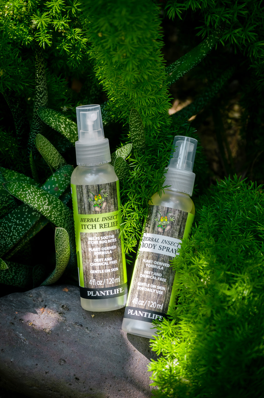 Plantlife Herbal Insect Body Spray and Itch Relief Spray 4 fl oz bottles shown outdoors in greenery with plant-derived DEET-free formulas