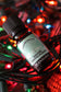 Bottle of Plantlife essential oil blend with colorful lights in the background