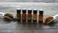Plantlife Essential Oils with Spices – Aromatherapy Bottles Styled with Natural Ingredients on Rustic Wood Surface for Warm, Inviting Wellness