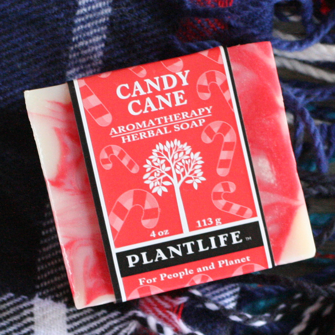 Candy Cane Aromatherapy Herbal Soap packaging with Plantlife branding on a textured fabric background
