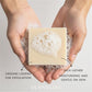 Hands holding a bar of soap with loofah, labeled 'Plantlife'.