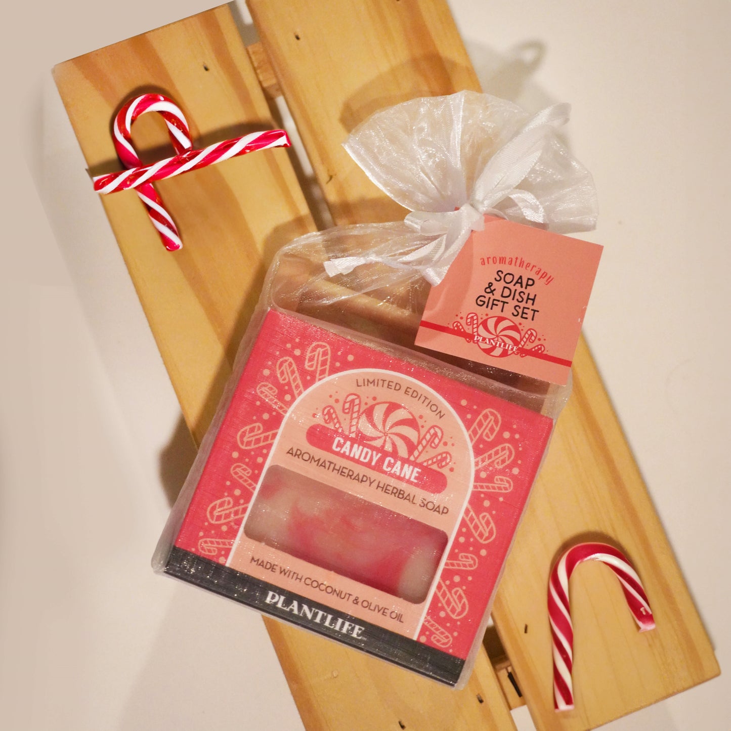 Candy Cane Aromatherapy Herbal Soap with a soap dish on a wooden board