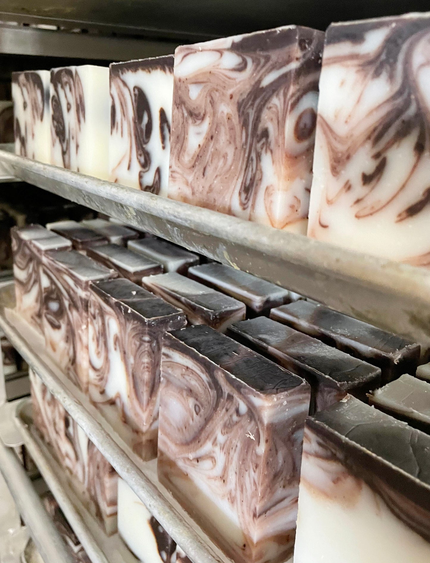 Marbled soap bars on metal shelves